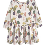The Mabel and Honey Treehouse Dress is a long-sleeve, knee-length dress for kids with a flared skirt, showcasing a whimsical tree pattern in green, pink, purple, and yellow—ideal for nature-inspired style lovers.