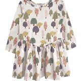 The Mabel and Honey Treehouse Dress is a long-sleeve, knee-length dress for kids with a flared skirt, showcasing a whimsical tree pattern in green, pink, purple, and yellow—ideal for nature-inspired style lovers.