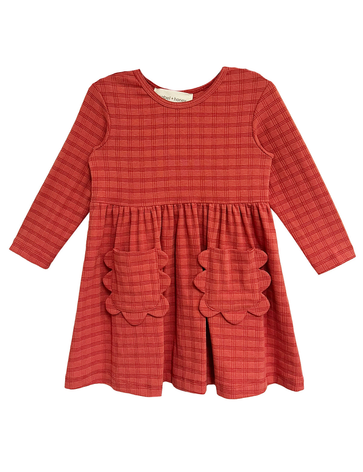 The Mabel and Honey Tea Party Red Gingham Dress features long sleeves, a round neck, gathered waist, and two scalloped skirt pockets—combining comfort and classic style for any occasion.