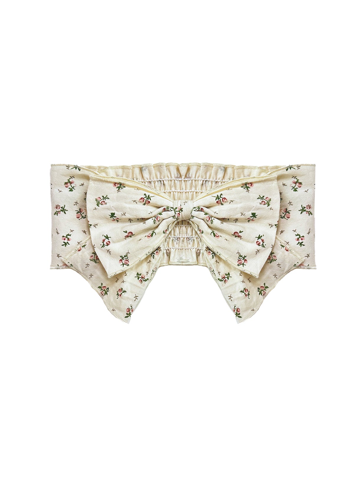 The Juliette Hair Accessory by Mabel and Honey features a cream base with a pink floral print, a large pink flower bow at the center, pointed edges, and an elastic ruched band for comfort.