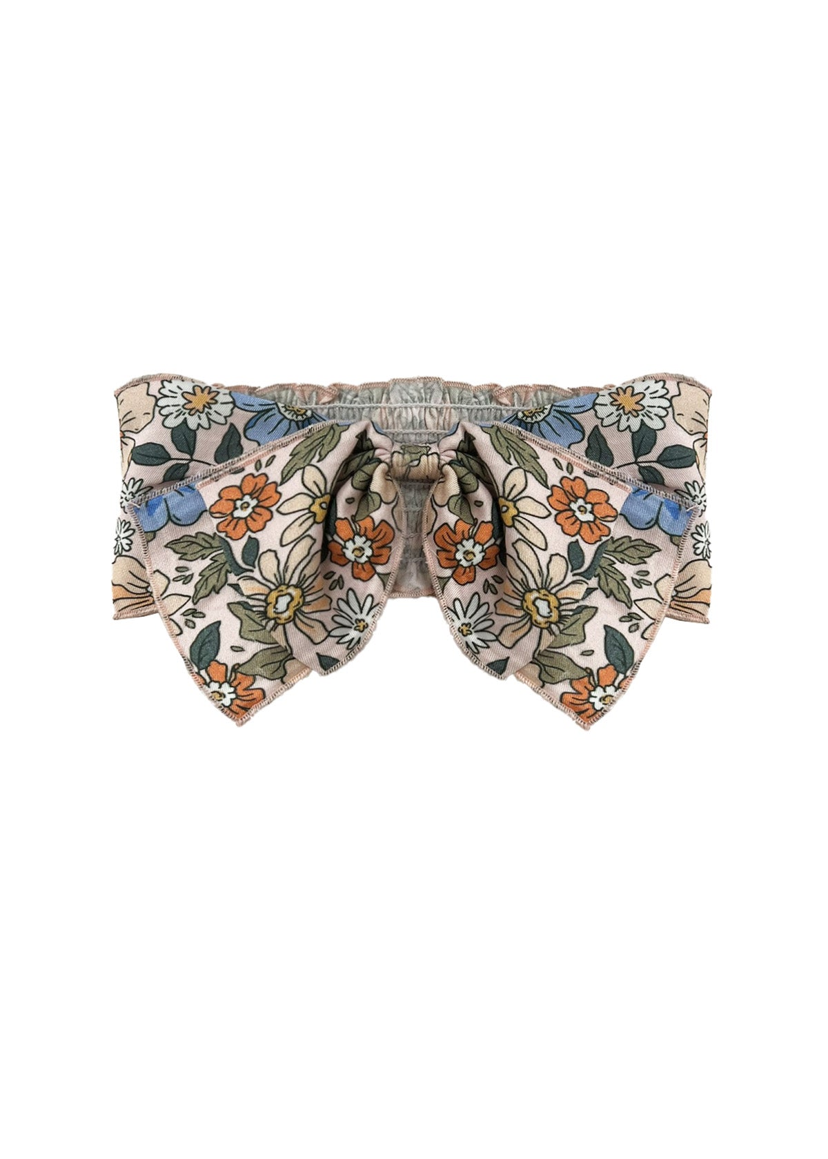 The Riley Hair Accessory by Mabel and Honey is a baby girl bow with orange, blue, and white flowers plus green leaves on beige. It features a gathered center and pointed ends for added charm.