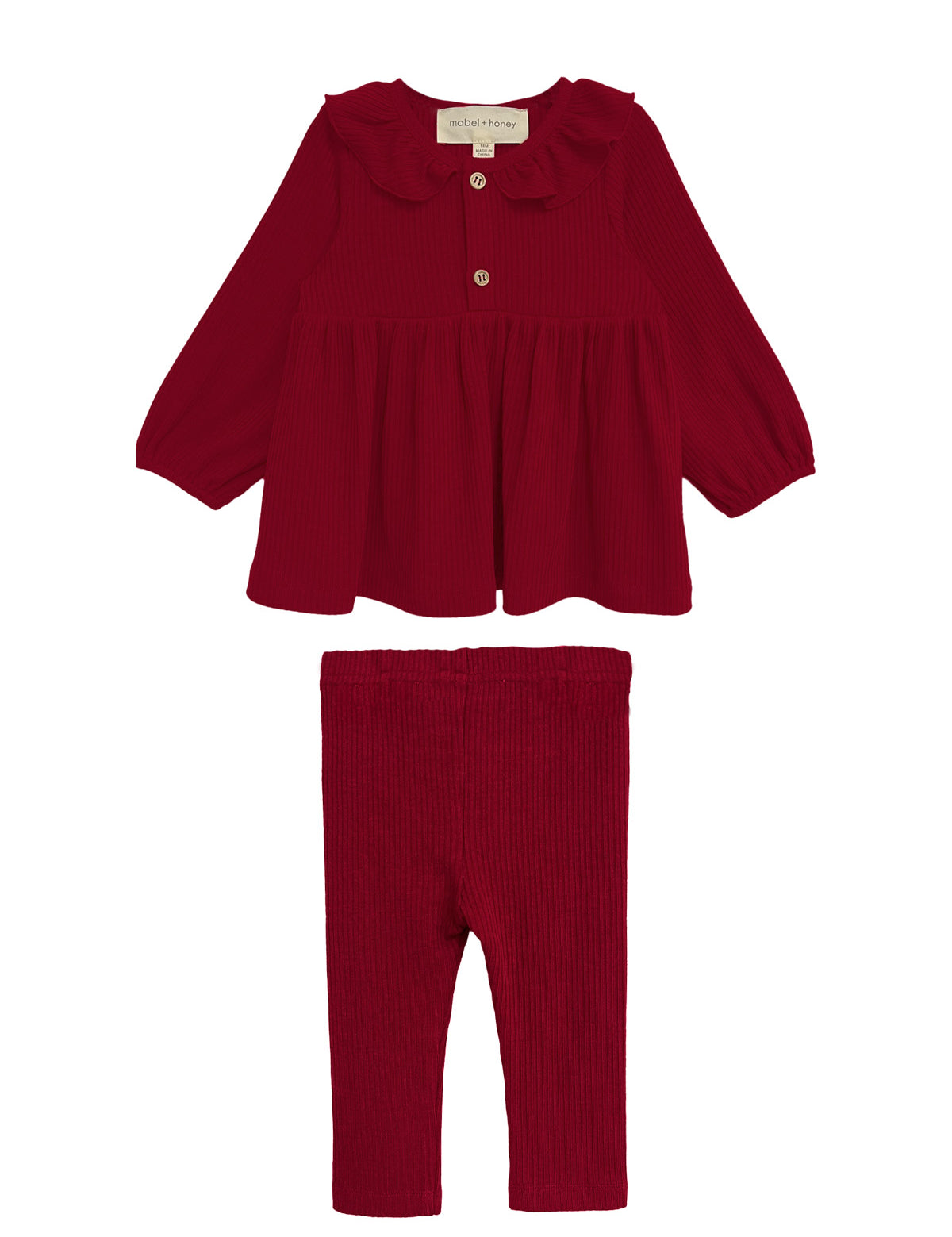 The Rosie Two Piece Set by Mabel and Honey features a deep red, long-sleeved top with a ruffled collar and front button, paired with matching ribbed leggings. Both pieces are displayed on a white background.