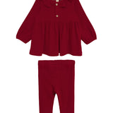 The Rosie Two Piece Set by Mabel and Honey features a deep red, long-sleeved top with a ruffled collar and front button, paired with matching ribbed leggings. Both pieces are displayed on a white background.