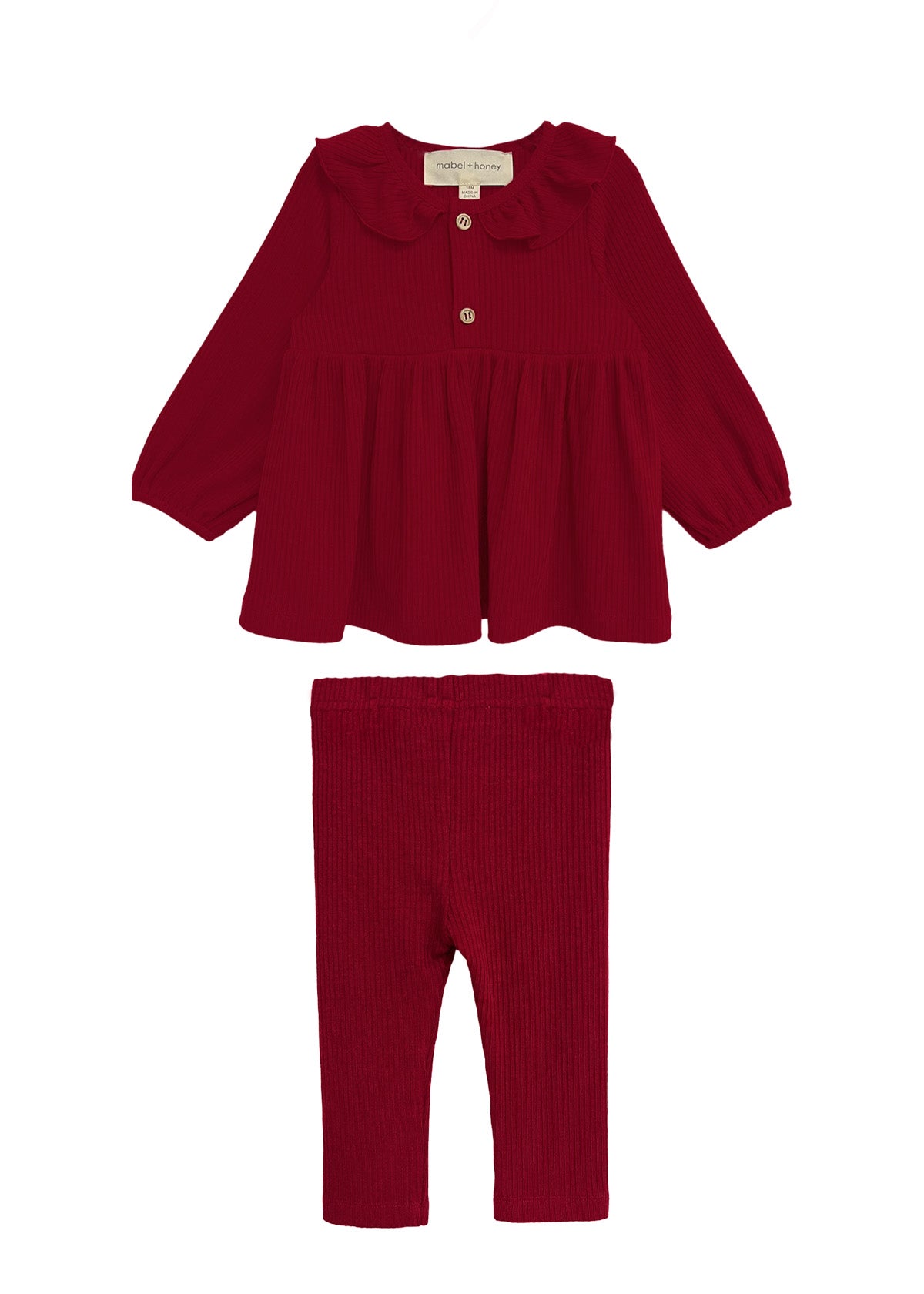 The Rosie Two Piece Set by Mabel and Honey features a deep red, long-sleeved top with a ruffled collar and front button, paired with matching ribbed leggings. Both pieces are displayed on a white background.