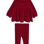 The Mabel and Honey Rosie Two Piece Set features a red long-sleeve, ruffled-collar top with flared hem and matching ribbed leggings, both made from cozy ribbed fabric and shown against a white background.