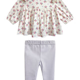The Mia Two Piece Set by Mabel and Honey includes a floral blouse with a ruffled collar and long sleeves, paired with light purple leggings—an adorable outfit for girls.