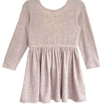 The Heather Dress by Mabel and Honey features a ribbed texture, gathered skirt, and simple round neckline in light pink, offering timeless, effortless style with no visible buttons or embellishments.