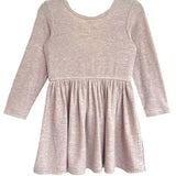 The Heather Dress by Mabel and Honey features a ribbed texture, gathered skirt, and simple round neckline in light pink, offering timeless, effortless style with no visible buttons or embellishments.