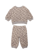 The Isaiah Two Piece Set by Beckett and Bear is a beige kids' pajama set with a brown animal print, long-sleeve top, pants, and light gray cuffs, hems, and collar. Shown on a white background.