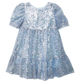 The Isobella and Chloe Starry Blue Glitter Dress is a light blue girls' party dress with shimmering sequins, puffy sleeves, a round neckline, flared gathered skirt, and a playful keyhole back opening.