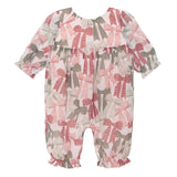The Bow-tiful Romper by Mabel and Honey is a charming long sleeve baby girl romper with ruffled cuffs and playful pink, red, and green bows on white, finished with gathered waist and ankles.