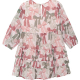The Bow-tiful Dress by Mabel and Honey features pink and green bow prints on white, ruffle details, a tiered skirt, and back buttons—ideal for girls who love pretty touches.
