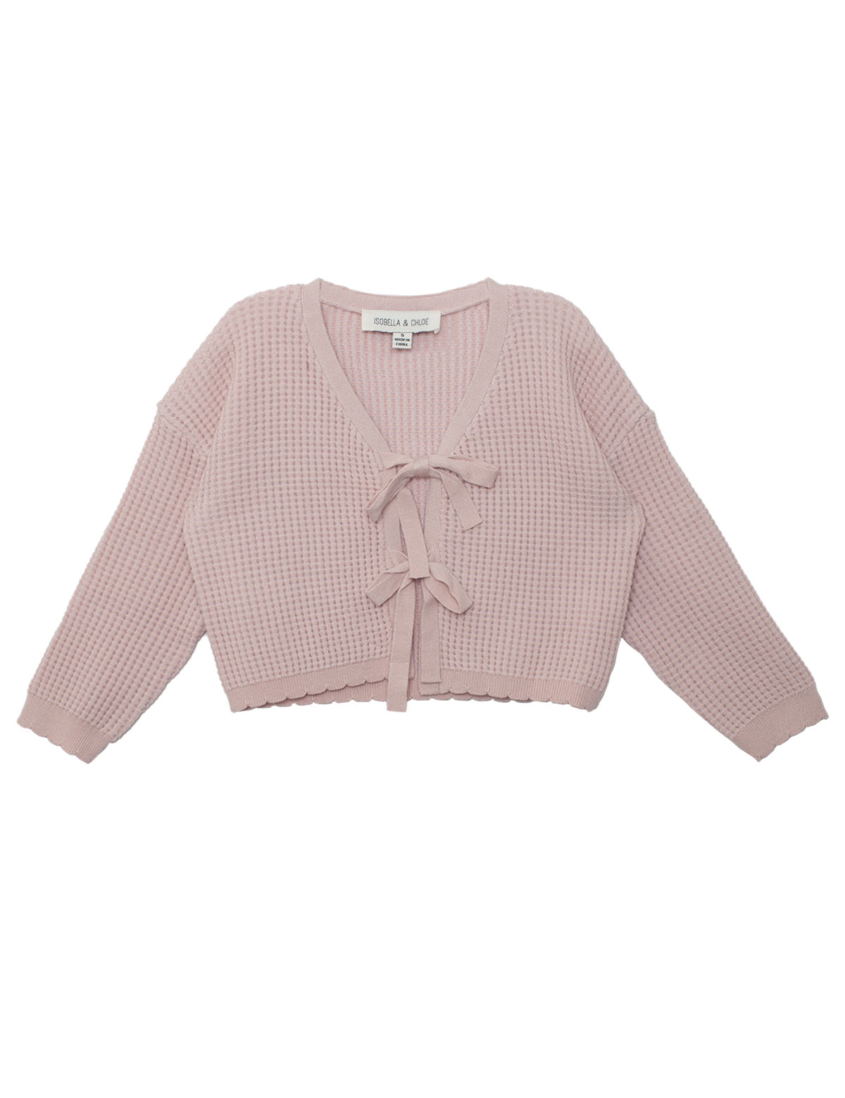 The Isobella and Chloe Ballerina Sweater features a light pink, long-sleeve, cropped waffle-knit design with a V-neckline and two front tie closures. The label is visible inside the neckline.