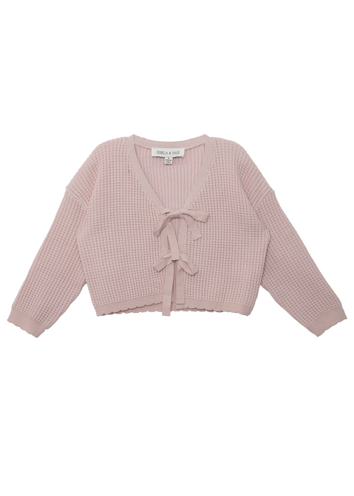 The Isobella and Chloe Ballerina Sweater features a light pink, long-sleeve, cropped waffle-knit design with a V-neckline and two front tie closures. The label is visible inside the neckline.