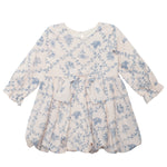The Mabel and Honey Princess Dress is a charming long-sleeved child's dress with a blue toile floral pattern, ruffled skirt, scalloped hem, and matching waist bow—perfect for special occasions.