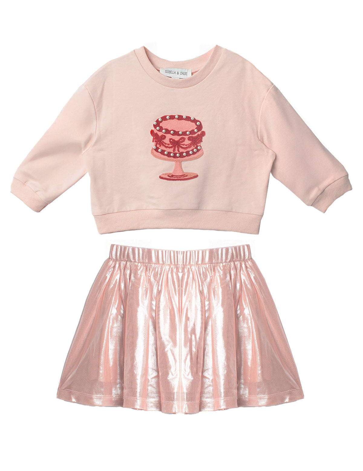 The Isobella and Chloe Sweet Cakes Two Piece Set features a light pink embroidered cake long-sleeve top and a shiny metallic pink skirt—perfect for sweet style in any girl’s wardrobe.