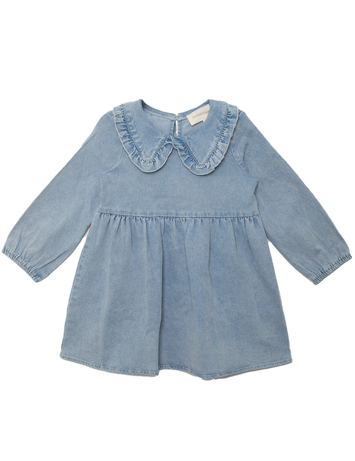 The Mabel and Honey Denim Days Long Sleeve Dress is a charming light blue denim A-line dress for kids, featuring a ruffled Peter Pan collar and gathered waist, shown on a white background.