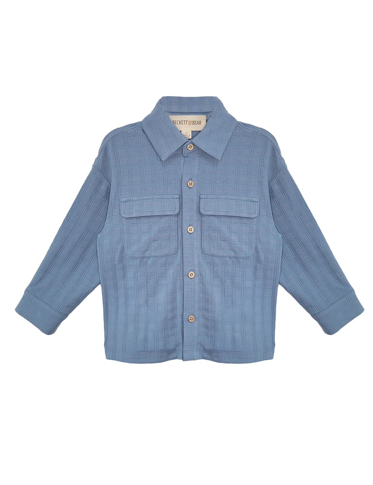The Lucas Jacket by Beckett and Bear is a light blue, long-sleeve jacket with a collar, button-down front, two chest flap pockets, and ribbed texture. The sleeves are slightly spread out to the sides.