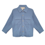 The Lucas Jacket by Beckett and Bear is a light blue, long-sleeve jacket with a collar, button-down front, two chest flap pockets, and ribbed texture. The sleeves are slightly spread out to the sides.