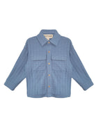 The Lucas Jacket by Beckett and Bear is a light blue, long-sleeve jacket with a collar, button-down front, two chest flap pockets, and ribbed texture. The sleeves are slightly spread out to the sides.