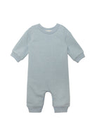The Beckett and Bear Aiden Romper is a light blue long-sleeve baby romper with ribbed cuffs and inseam snap closures for easy changing.