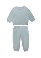 The Beckett and Bear Aiden Two Piece Set features a light blue long-sleeve crewneck sweatshirt and matching elastic-waist jogger sweatpants, shown on a plain white background.