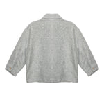 The Grayson Jacket by Beckett and Bear is a light gray corduroy kids layering jacket with long sleeves, a collar, and buttoned cuffs. Shown from the back on a white background, its subtle textured pattern adds stylish detail.