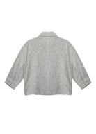 The Grayson Jacket by Beckett and Bear is a light gray corduroy kids layering jacket with long sleeves, a collar, and buttoned cuffs. Shown from the back on a white background, its subtle textured pattern adds stylish detail.