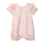The Mabel and Honey Wild Savanna Short Gathered Sleeve Romper has ruffled sleeves, a pink, yellow, and green floral print on white, elastic leg openings, and a round neckline for lightweight comfort and style.