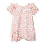 The Mabel and Honey Wild Savanna Short Gathered Sleeve Romper has ruffled sleeves, a pink, yellow, and green floral print on white, elastic leg openings, and a round neckline for lightweight comfort and style.
