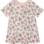 The Quinn Short Sleeve Dress by Mabel and Honey is a light pink, breathable dress with yellow and pink floral patterns, green leaves, and a solid collar—perfect for comfortable everyday wear.