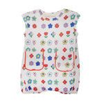 The Mabel and Honey Little Garden Parade Cap Sleeve Romper features playful colorful floral prints, two red-outlined front pockets, a comfy elastic hem, and is perfect for everyday wear.