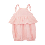 The Pinky Linky Sleeveless with Knot Detail Romper by Mabel and Honey features shoulder tie straps, a ruffled chest overlay, elastic leg openings, and a subtle textured knit pattern in light pink against a plain white background.