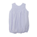The Magnolia Sleeveless Romper by Mabel and Honey features light purple and white vertical stripes, a smocked yoke, and a gentle bubble silhouette. Shown on a white background.