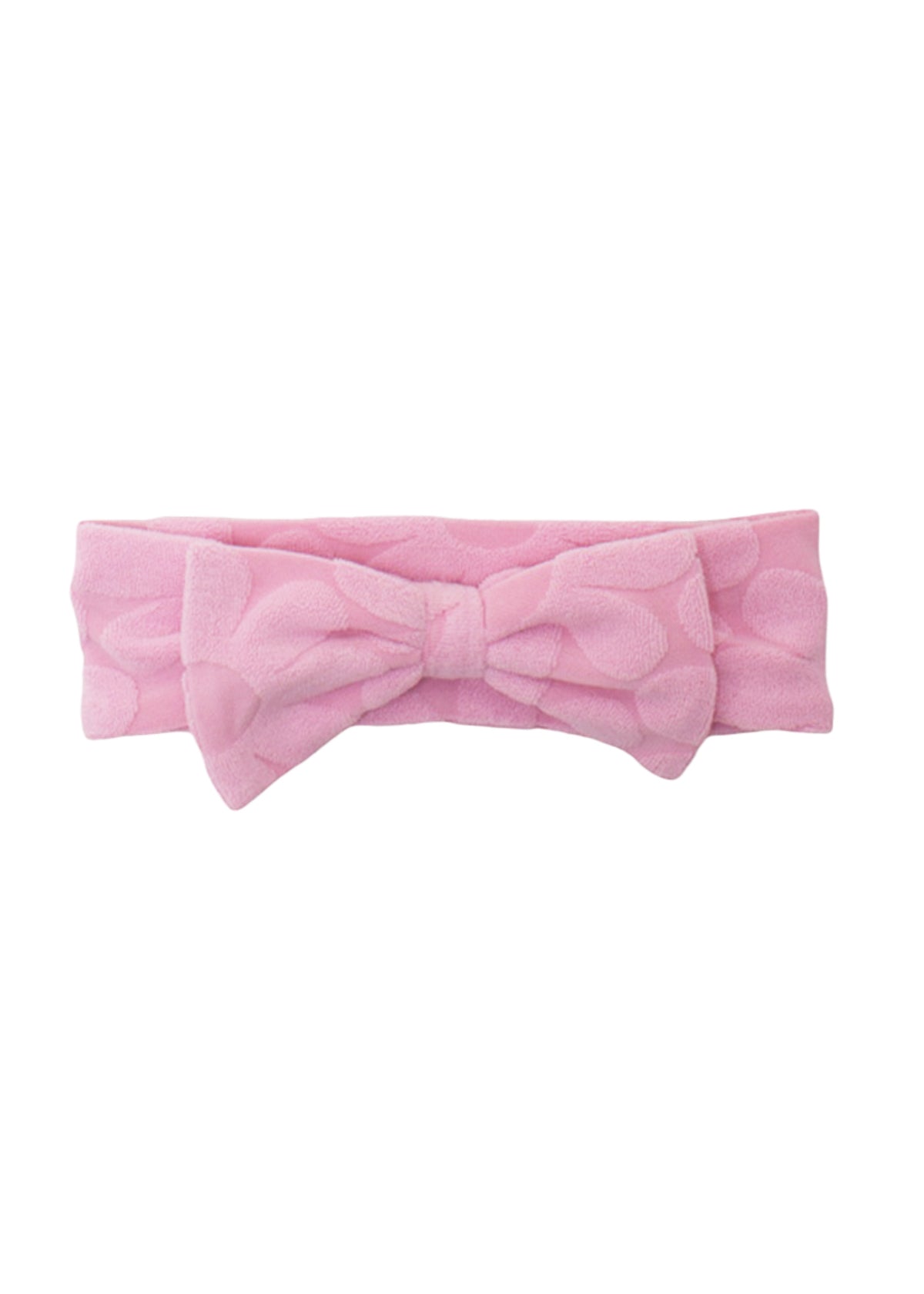 The Tilly Hair Accessory by Mabel and Honey is a soft pink terrycloth headband with a textured pattern and a large center bow, making it both adorable and comfortable.