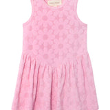 The Mabel and Honey Tilly Short Sleeve Dress is a children's pink dress with a round neckline, gathered skirt, and light pink daisy pattern—perfect for summer outings or as a cute beach cover-up.