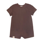 The Nash Short Sleeve Romper by Beckett and Bear is a solid brown baby one-piece with a crew neck, short sleeves, and short legs in soft knit fabric. It features a small tag near the lower left hem and is shown on a white background.