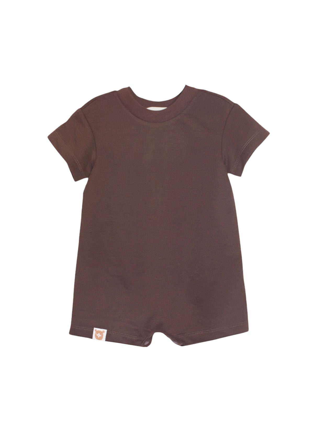 The Nash Short Sleeve Romper by Beckett and Bear is a solid brown baby one-piece with a crew neck, short sleeves, and short legs in soft knit fabric. It features a small tag near the lower left hem and is shown on a white background.