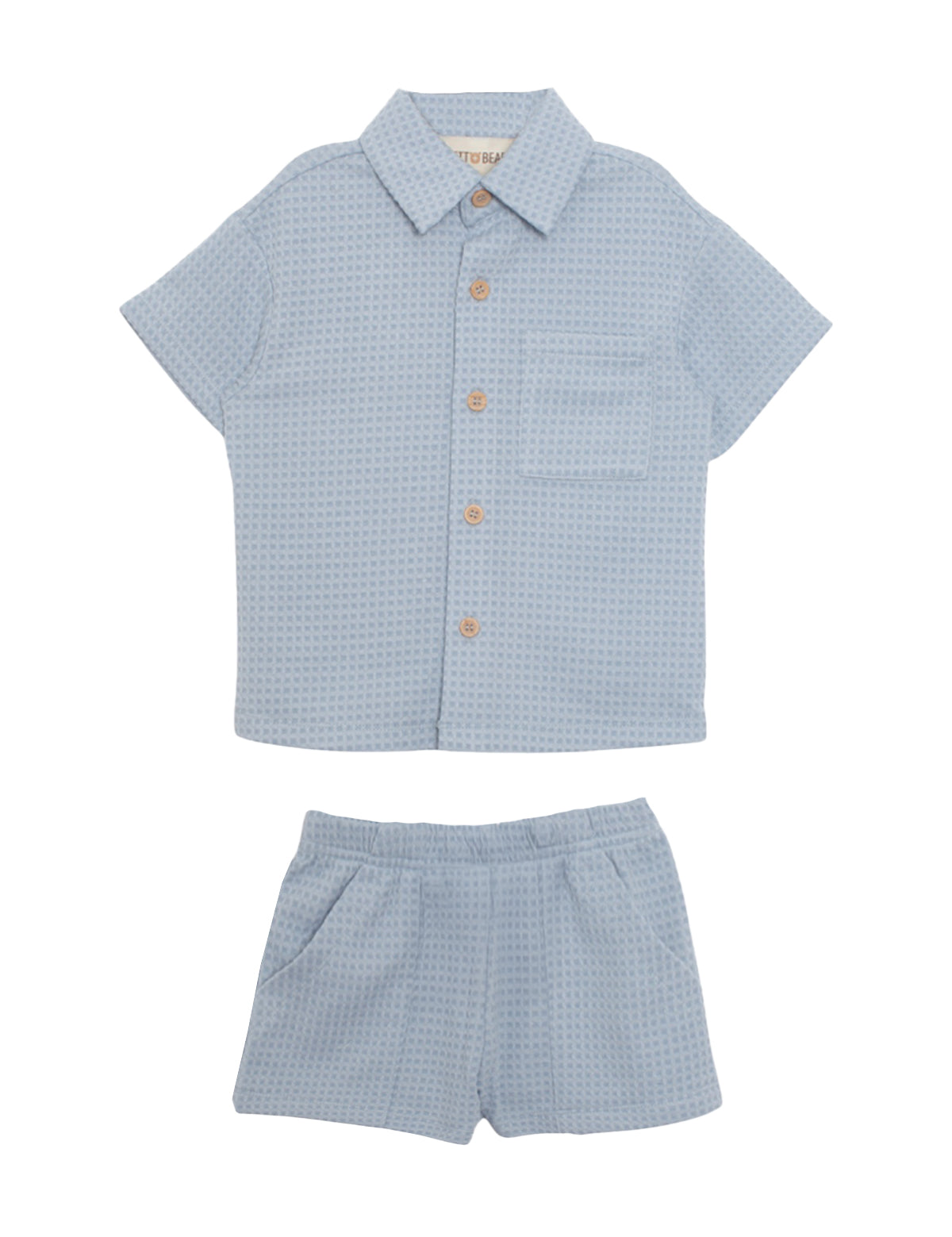 The Beckett and Bear Rowland Short Sleeve Two Piece Set features a light blue checkered shirt with brown buttons and chest pocket, plus matching shorts. Both pieces are laid flat on a white background.