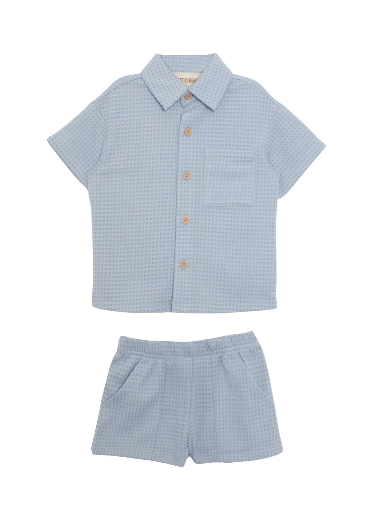 The Beckett and Bear Rowland Short Sleeve Two Piece Set features a light blue checkered shirt with brown buttons and chest pocket, plus matching shorts. Both pieces are laid flat on a white background.