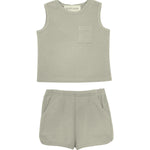 The Russell Sleeveless Two Piece Set by Beckett and Bear features a light grey waffle-knit top with a chest pocket and matching shorts with an elastic waistband and side pockets, displayed on a white background.
