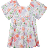 The Lavender Daze Puff Sleeve Dress by Mabel and Honey features short puffy sleeves, a gathered waist, and a pastel floral watercolor print in pink, orange, and purple on white.