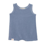 The Axel Sleeveless Romper by Beckett and Bear is a light blue, terry cloth baby romper with a round neckline, sleeveless design, and a small beige tag at the bottom left hem.