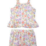 The Mabel and Honey Tulip Twirl Tank Two Piece Set features a sleeveless top and shorts with pink, purple, and orange flowers on a light background—perfect summer clothes or a cute toddler outfit.