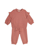 The Mabel and Honey Red Velvet Two Piece Set is a cozy pink knit toddler outfit with red polka dots, ruffled shoulders, and matching pants.