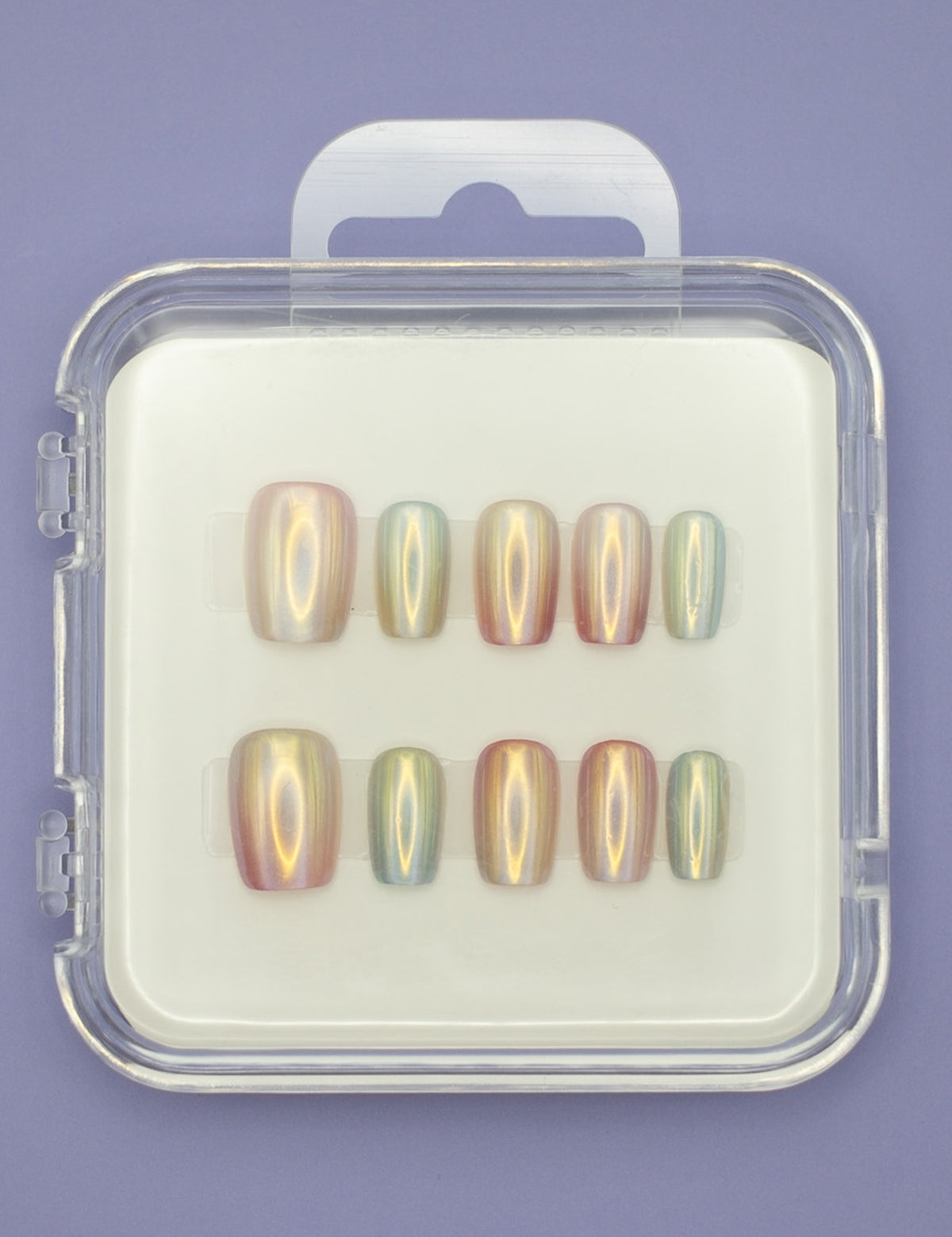 The "Seashells" by Mabel and Honey features ten salon-quality press-on nails in assorted sizes, elegantly arranged in a clear plastic case on a white background with a light purple surface underneath.