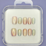 The "Seashells" by Mabel and Honey features ten salon-quality press-on nails in assorted sizes, elegantly arranged in a clear plastic case on a white background with a light purple surface underneath.