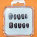 Cheetah Chic by Mabel and Honey features ten glossy, dark brown press-on nails in assorted sizes, arranged in a clear plastic case with a white insert and orange background for a salon-quality manicure at home.
