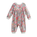 The Eliza Romper Long Sleeve Floral Bubble Romper by Mabel + Honey is a baby romper featuring long sleeves and a charming floral print in pink, gray, and white tones. It is designed with ribbed cuffs at the wrists and ankles, as well as a gathered seam under the chest for added appeal.