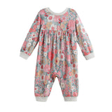 The Eliza Romper Long Sleeve Floral Bubble Romper by Mabel + Honey is a baby romper featuring long sleeves and a charming floral print in pink, gray, and white tones. It is designed with ribbed cuffs at the wrists and ankles, as well as a gathered seam under the chest for added appeal.